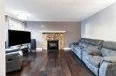 175-77 Glamis Green Sw, Calgary, AB  - Indoor Photo Showing Living Room With Fireplace 