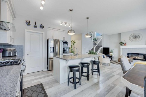 137 Amery Crest, Crossfield, AB - Indoor Photo Showing Kitchen With Fireplace With Stainless Steel Kitchen With Upgraded Kitchen