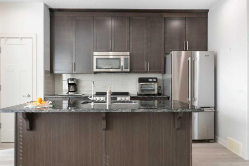 167 Fireside Drive, Cochrane, AB - Indoor Photo Showing Kitchen With Stainless Steel Kitchen With Upgraded Kitchen