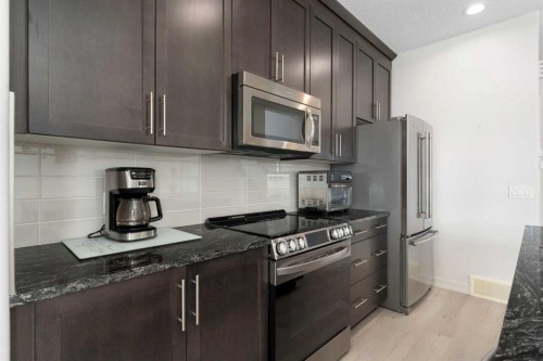 167 Fireside Drive, Cochrane, AB - Indoor Photo Showing Kitchen With Stainless Steel Kitchen