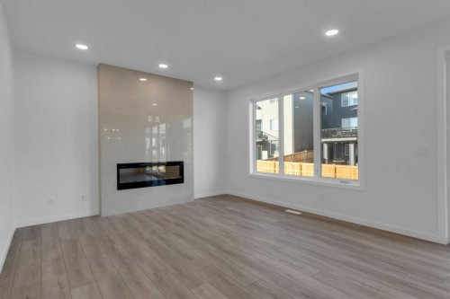 200 Starling Place Nw, Calgary, AB - Indoor Photo Showing Living Room With Fireplace