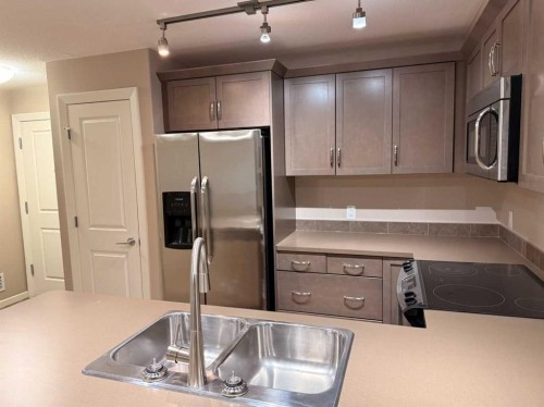 3104-402 Kincora Glen Road Nw, Calgary, AB - Indoor Photo Showing Kitchen With Stainless Steel Kitchen With Double Sink