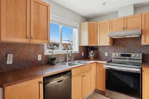 7 Bridleridge Link Sw, Calgary, AB - Indoor Photo Showing Kitchen With Stainless Steel Kitchen With Double Sink
