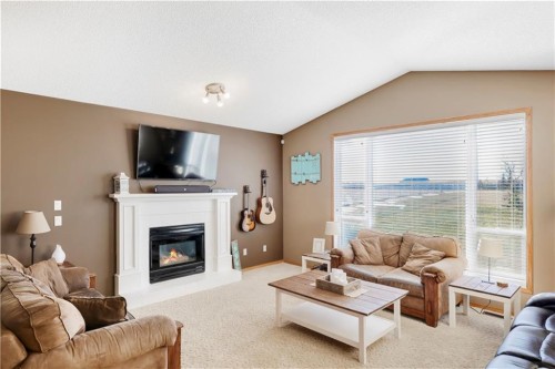 272210 Range Road 291 Ne, Airdrie, AB - Indoor Photo Showing Living Room With Fireplace