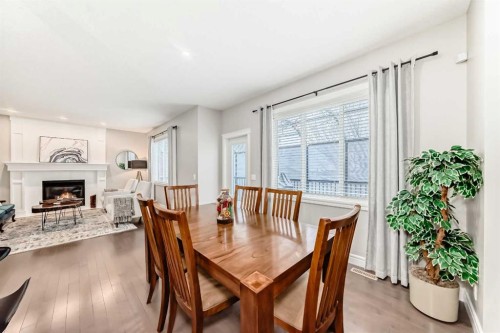 335 Morningside Crescent Sw, Airdrie, AB - Indoor Photo Showing Dining Room With Fireplace