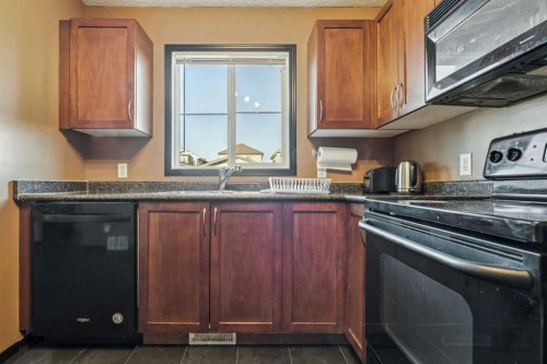 110 Eversyde Common Sw, Calgary, AB - Indoor Photo Showing Kitchen With Double Sink