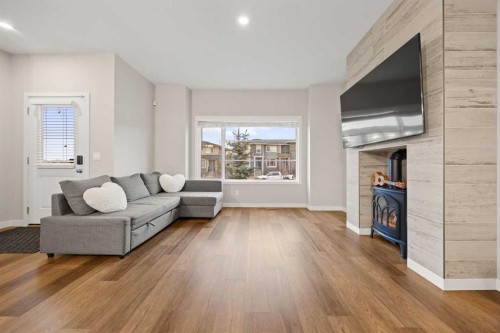 1027 Lanark Boulevard Se, Airdrie, AB - Indoor Photo Showing Living Room With Fireplace