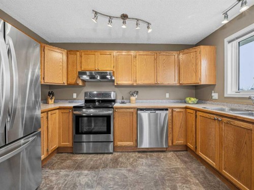301 Arbour Cliff Close Nw, Calgary, AB - Indoor Photo Showing Kitchen With Stainless Steel Kitchen With Double Sink