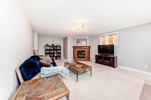 76 Tuscany Way Nw, Calgary, AB - Indoor Photo Showing Living Room With Fireplace