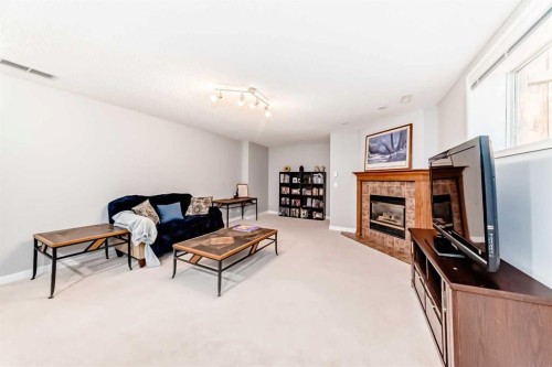 76 Tuscany Way Nw, Calgary, AB - Indoor Photo Showing Living Room With Fireplace