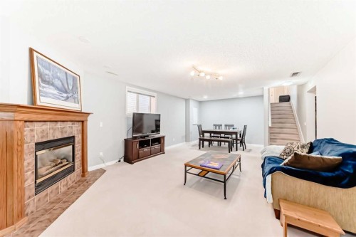 76 Tuscany Way Nw, Calgary, AB - Indoor Photo Showing Living Room With Fireplace