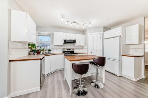 76 Tuscany Way Nw, Calgary, AB - Indoor Photo Showing Kitchen With Double Sink