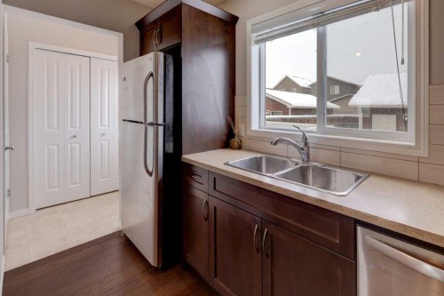 16 Fireside Way, Cochrane, AB - Indoor Photo Showing Kitchen With Double Sink