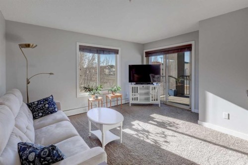 3301-403 Mackenzie Way Sw, Airdrie, AB - Indoor Photo Showing Living Room