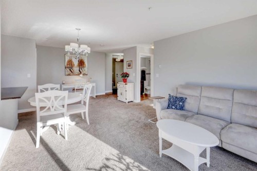 3301-403 Mackenzie Way Sw, Airdrie, AB - Indoor Photo Showing Living Room