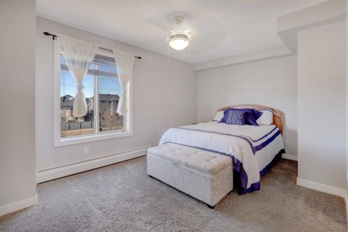 3301-403 Mackenzie Way Sw, Airdrie, AB - Indoor Photo Showing Bedroom
