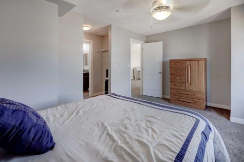 3301-403 Mackenzie Way Sw, Airdrie, AB - Indoor Photo Showing Bedroom