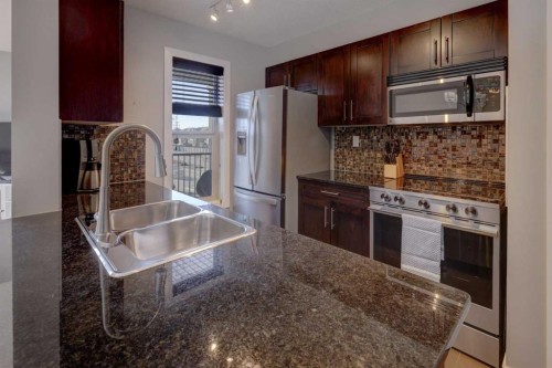 3301-403 Mackenzie Way Sw, Airdrie, AB - Indoor Photo Showing Kitchen With Stainless Steel Kitchen With Double Sink