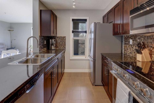 3301-403 Mackenzie Way Sw, Airdrie, AB - Indoor Photo Showing Kitchen With Stainless Steel Kitchen With Double Sink With Upgraded Kitchen