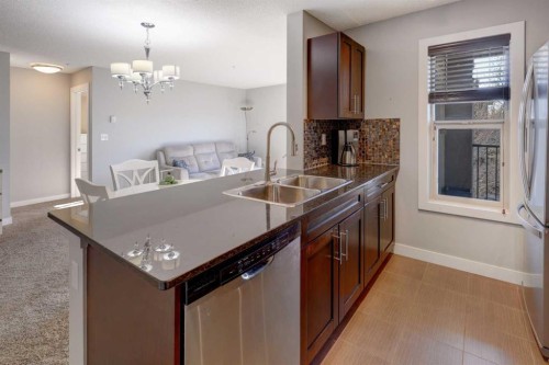 3301-403 Mackenzie Way Sw, Airdrie, AB - Indoor Photo Showing Kitchen With Double Sink