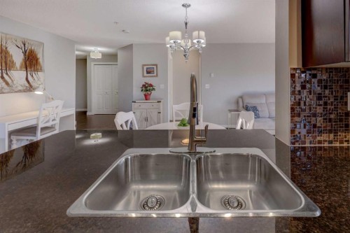 3301-403 Mackenzie Way Sw, Airdrie, AB - Indoor Photo Showing Kitchen With Double Sink