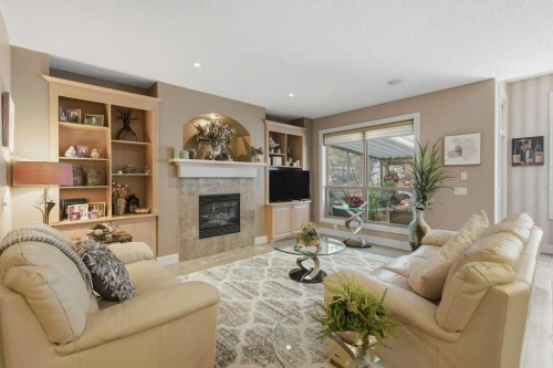 247 St Moritz Drive Sw, Calgary, AB - Indoor Photo Showing Living Room With Fireplace