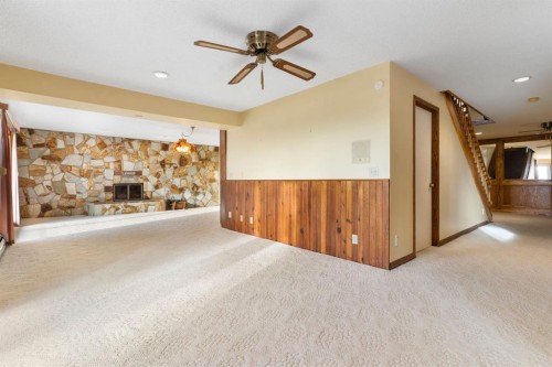 39 Coach Gate Way Sw, Calgary, AB - Indoor Photo Showing Other Room With Fireplace