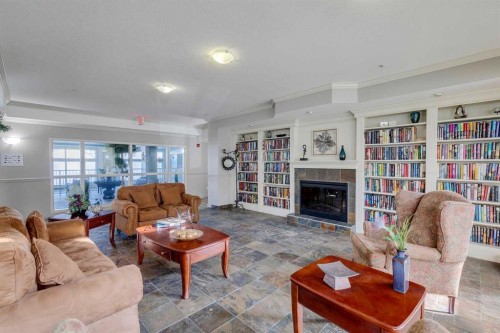 417-15 Everstone Drive Sw, Calgary, AB - Indoor Photo Showing Living Room With Fireplace