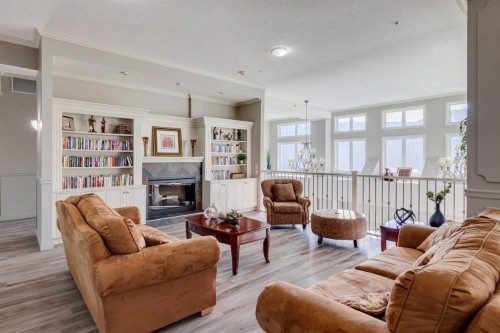 417-15 Everstone Drive Sw, Calgary, AB - Indoor Photo Showing Living Room With Fireplace