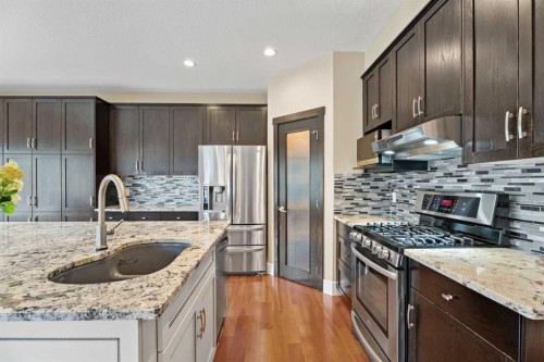 113 Aspen Stone Place Sw, Calgary, AB - Indoor Photo Showing Kitchen With Double Sink With Upgraded Kitchen