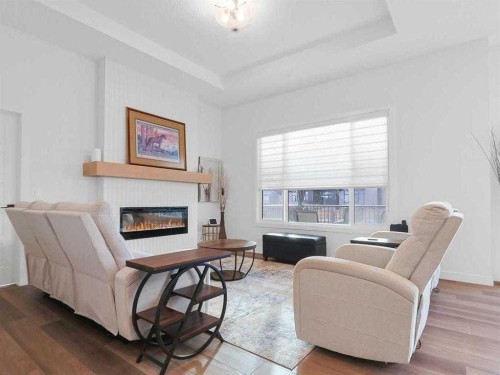 110 Sunstone Way, Balzac, AB - Indoor Photo Showing Living Room With Fireplace