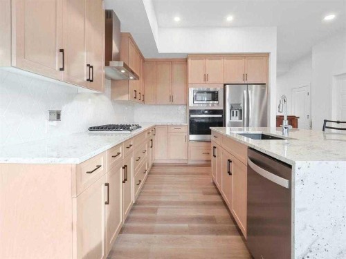 110 Sunstone Way, Balzac, AB - Indoor Photo Showing Kitchen With Upgraded Kitchen