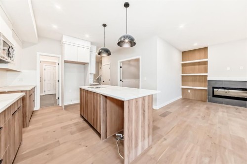 508 Heritage Boulevard, Cochrane, AB - Indoor Photo Showing Kitchen With Fireplace