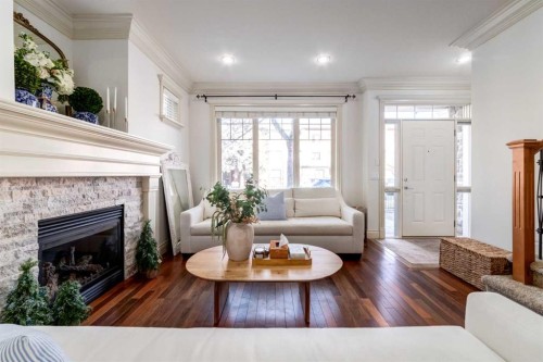 1-2413 2 Avenue Nw, Calgary, AB - Indoor Photo Showing Living Room With Fireplace