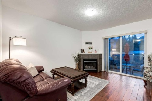 142 Eversyde Common Sw, Calgary, AB - Indoor Photo Showing Living Room With Fireplace