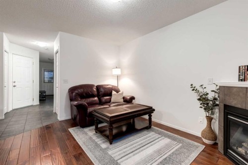 142 Eversyde Common Sw, Calgary, AB - Indoor Photo Showing Living Room With Fireplace