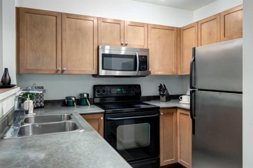 142 Eversyde Common Sw, Calgary, AB - Indoor Photo Showing Kitchen With Double Sink