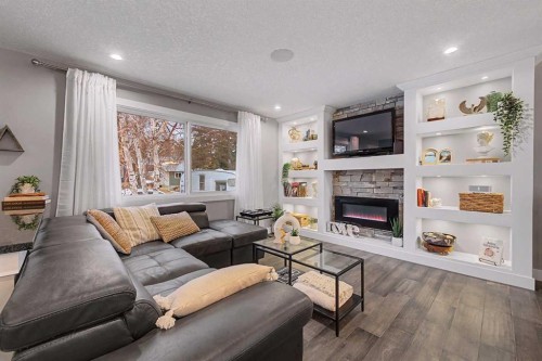 32 Sinclair Crescent Sw, Calgary, AB - Indoor Photo Showing Living Room With Fireplace