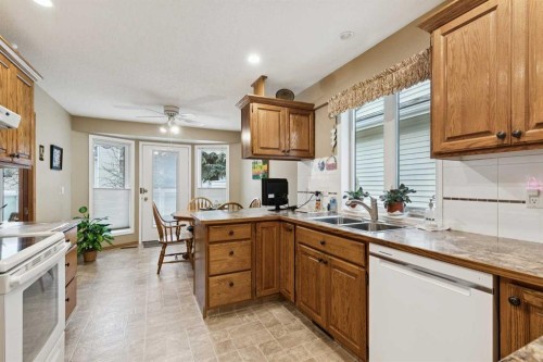 1025 Shawnee Road Sw, Calgary, AB - Indoor Photo Showing Kitchen With Double Sink