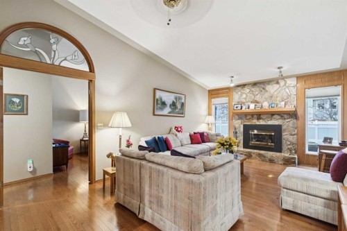 1025 Shawnee Road Sw, Calgary, AB - Indoor Photo Showing Living Room With Fireplace