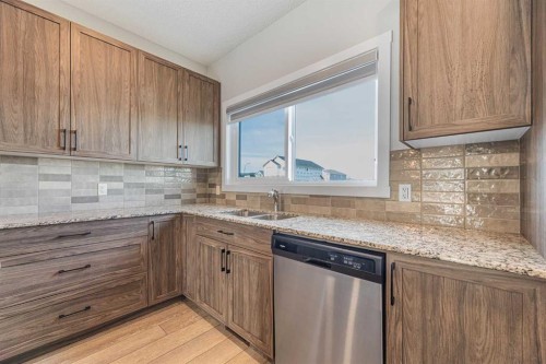 747 Creekside Boulevard Sw, Calgary, AB - Indoor Photo Showing Kitchen With Double Sink
