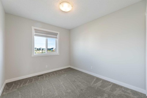 747 Creekside Boulevard Sw, Calgary, AB - Indoor Photo Showing Other Room
