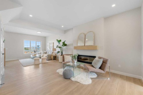 84 Buffaloberry Manor Se, Calgary, AB - Indoor Photo Showing Living Room With Fireplace