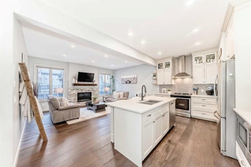 743 Shawnee Drive Sw, Calgary, AB - Indoor Photo Showing Kitchen With Fireplace With Double Sink With Upgraded Kitchen