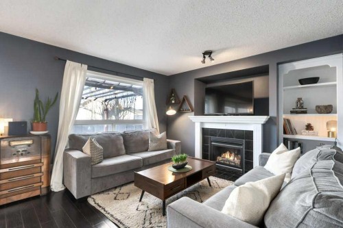 28 Everstone Way Sw, Calgary, AB - Indoor Photo Showing Living Room With Fireplace