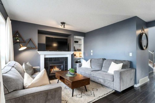 28 Everstone Way Sw, Calgary, AB - Indoor Photo Showing Living Room With Fireplace