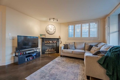 101-3704 15A Street Sw, Calgary, AB - Indoor Photo Showing Living Room With Fireplace