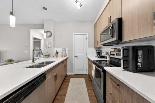 302-200 Cranfield Common Se, Calgary, AB - Indoor Photo Showing Kitchen With Double Sink With Upgraded Kitchen