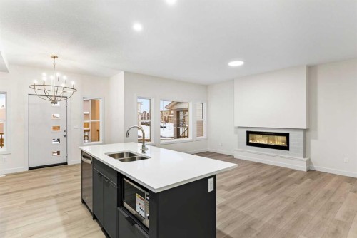 43 Belvedere Point Se, Calgary, AB - Indoor Photo Showing Kitchen With Fireplace With Double Sink
