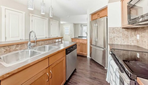 822 Panatella Boulevard Nw, Calgary, AB - Indoor Photo Showing Kitchen With Double Sink